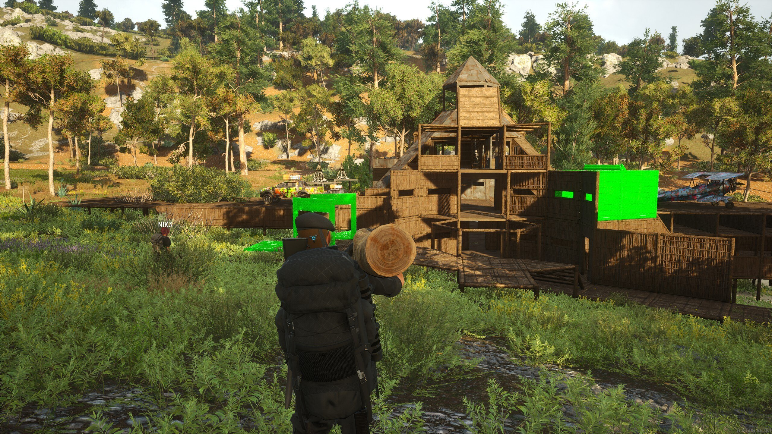 SCUM player character carrying heavy logs through the forest